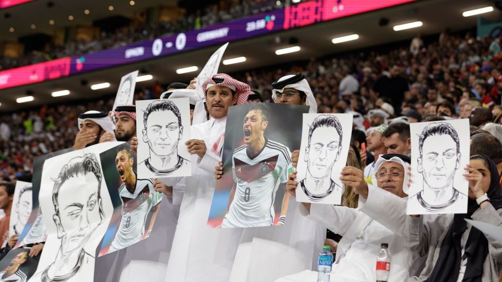 Qataris hold up Ozil signs in Germany response
